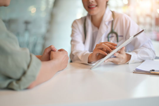 Ärztin spricht mit Patienten